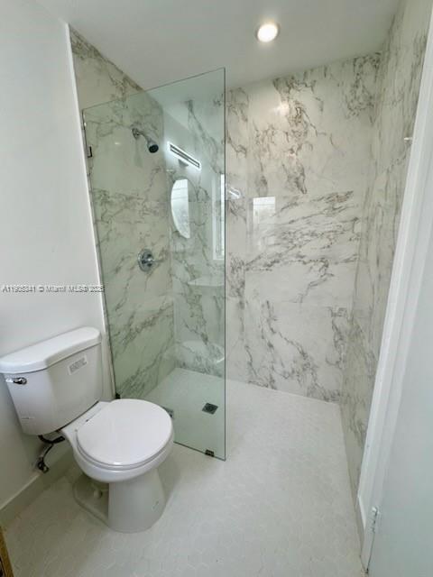 7300 Byron Avenue, Unit 10 Miami Beach, FL 33141 - Photo 10 of 10 a white toilet sitting next to a bathroom sink