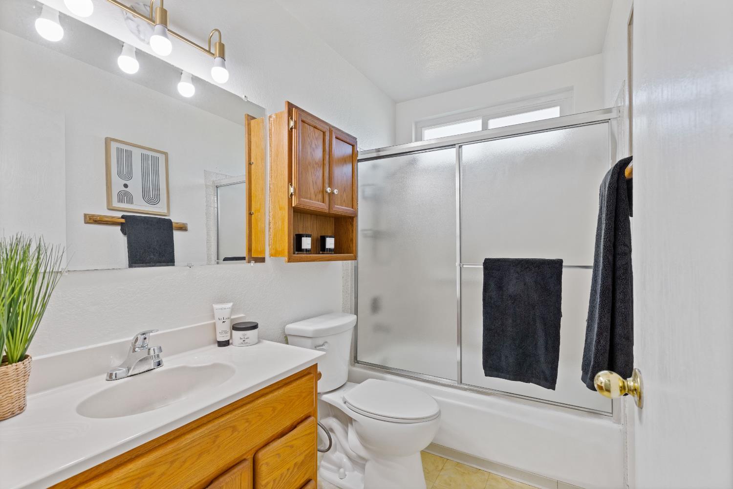 7208 Parkvale Way Citrus Heights, CA 95621 - Photo 14 of 18 a bathroom with a sink toilet and shower