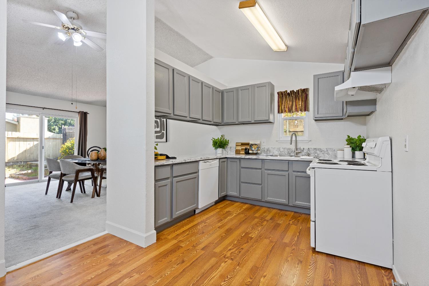 7208 Parkvale Way Citrus Heights, CA 95621 - Photo 7 of 18 a kitchen with cabinets and wooden floor
