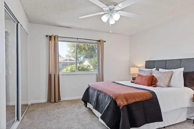 a bedroom with a large bed and a window