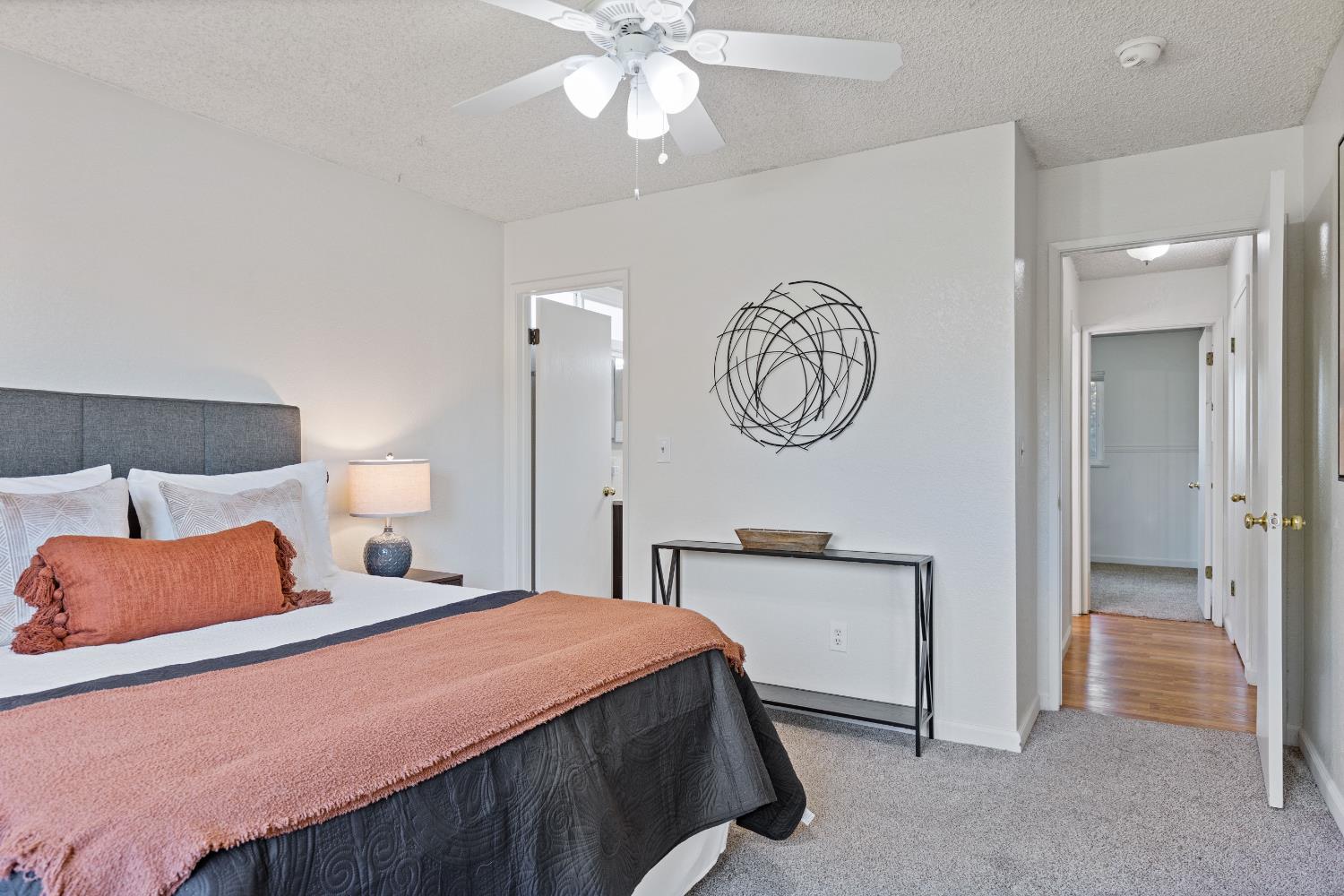 7208 Parkvale Way Citrus Heights, CA 95621 - Photo 9 of 18 a bedroom with a bed and a chandelier