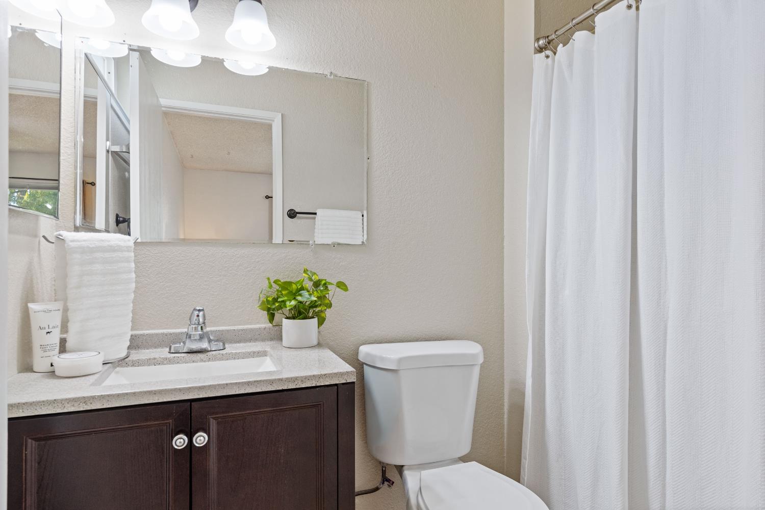 7208 Parkvale Way Citrus Heights, CA 95621 - Photo 10 of 18 a bathroom with a toilet a sink and a mirror