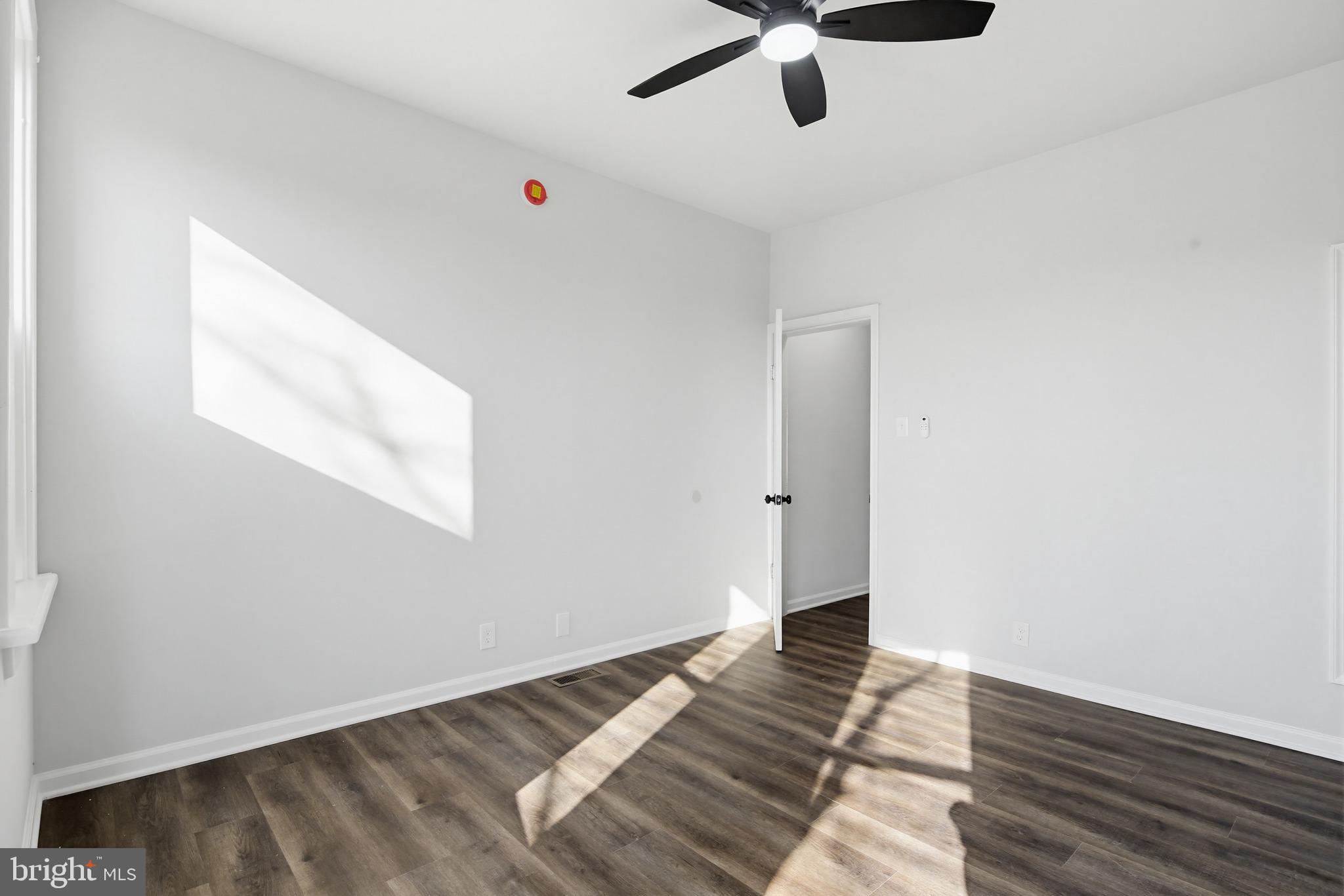 1244 Carroll Street Baltimore, MD 21230 - Photo 14 of 30 a view of an empty room with wooden floor and a window