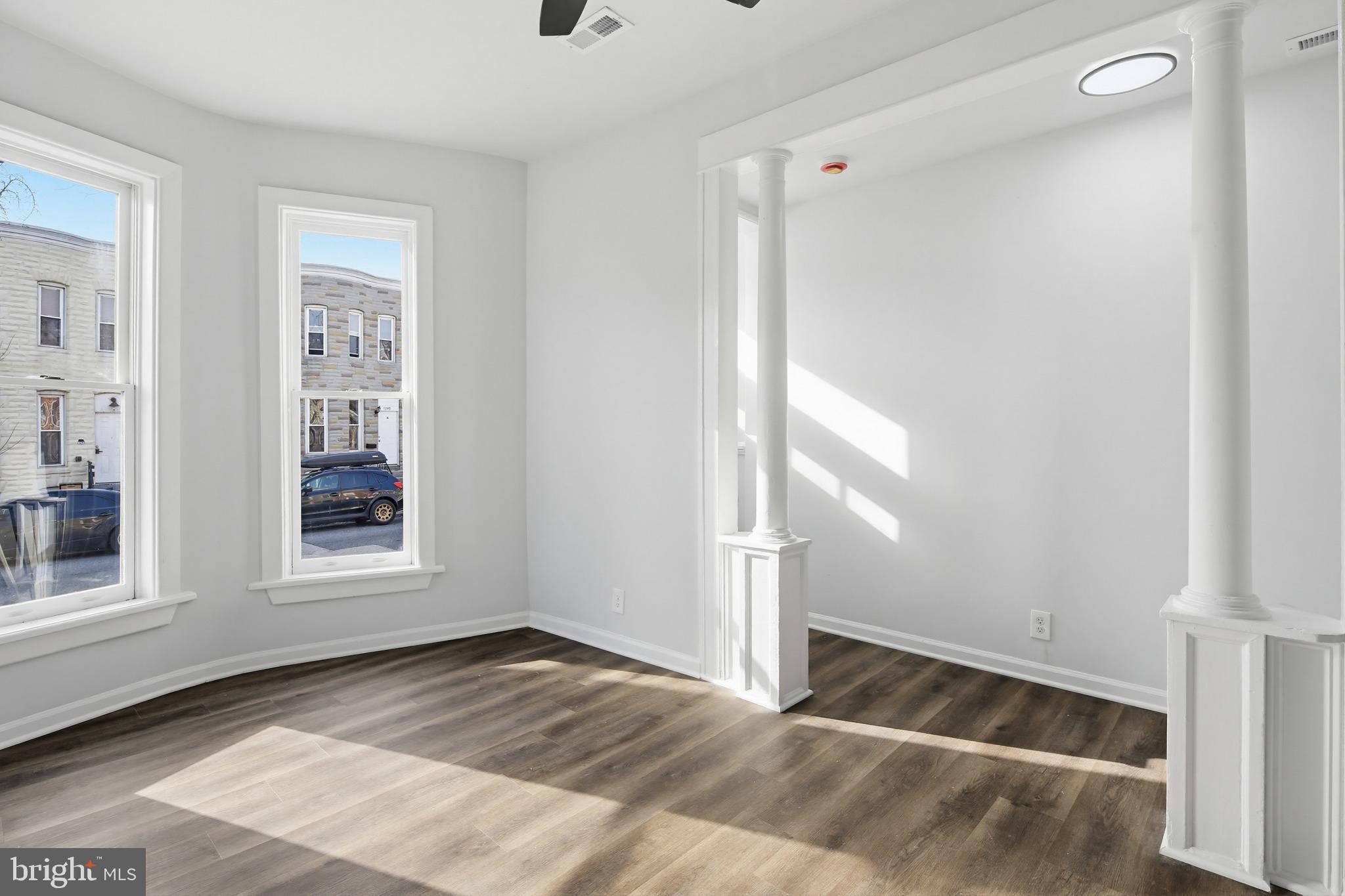 1244 Carroll Street Baltimore, MD 21230 - Photo 26 of 30 a view of an empty room with wooden floor and a window
