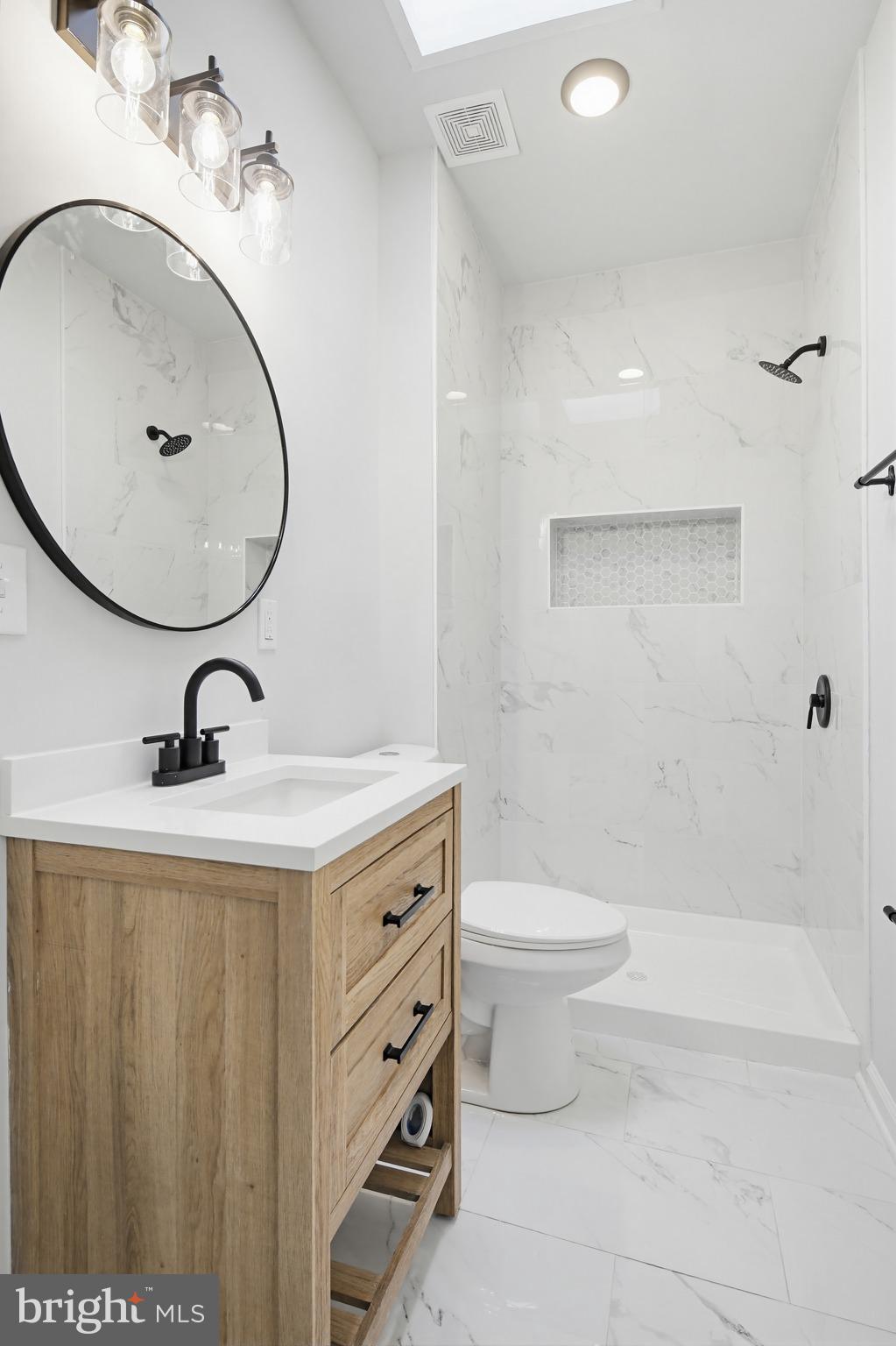 1244 Carroll Street Baltimore, MD 21230 - Photo 9 of 30 a bathroom with a sink a toilet and a mirror