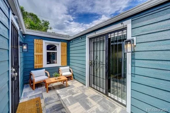 a backyard of a house with outdoor seating