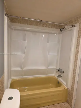 a bathroom with a shower and a bath tub