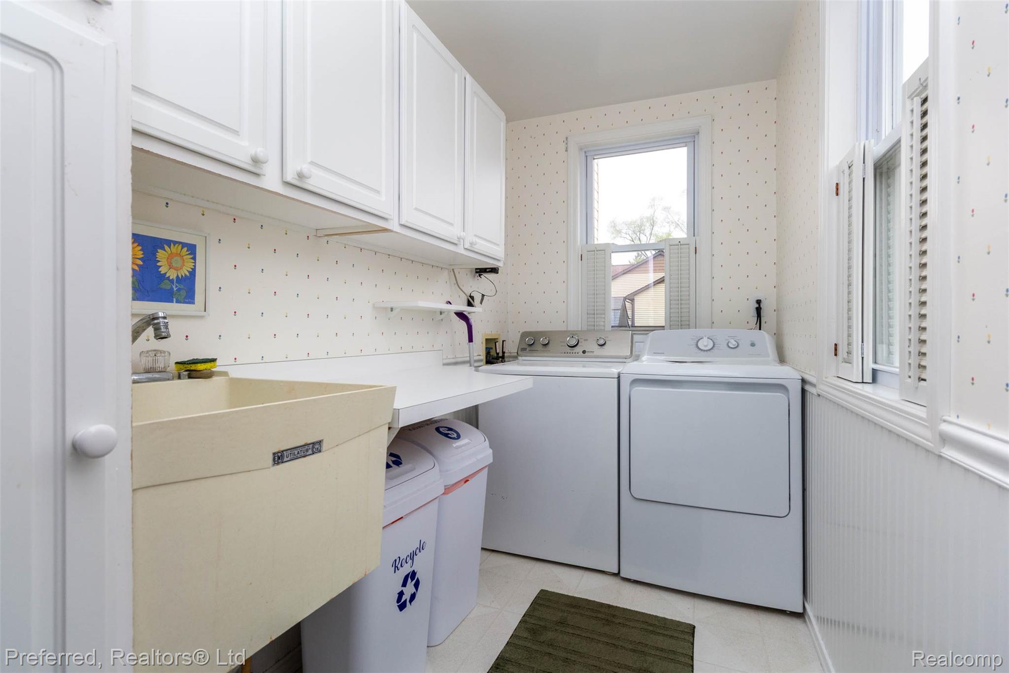 9840 Currie Road Northville, MI 48167 - Photo 33 of 62 Laundry area featuring washer and dryer and cabinet space