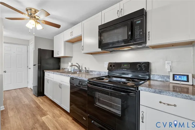 a kitchen with stainless steel appliances granite countertop a stove microwave sink and refrigerator