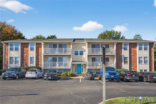a front view of a residential apartment building with a yard