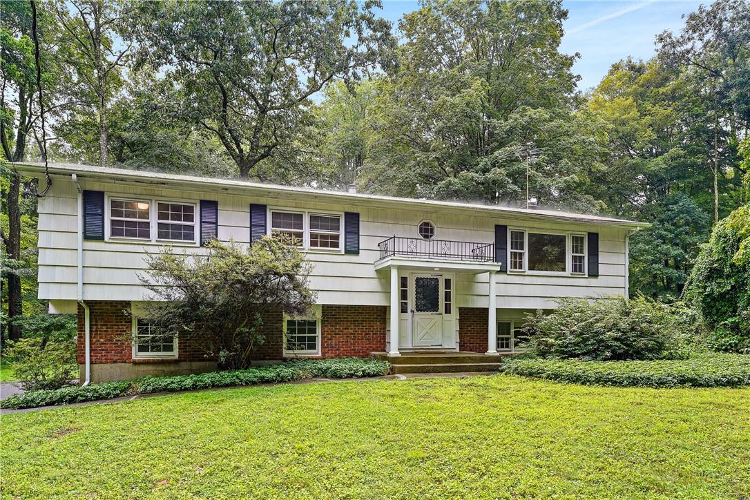 109 Horseshoe Hill Road Pound Ridge, NY 10576 - Photo 1 of 1 a view of a house with a yard potted plants and a table chair