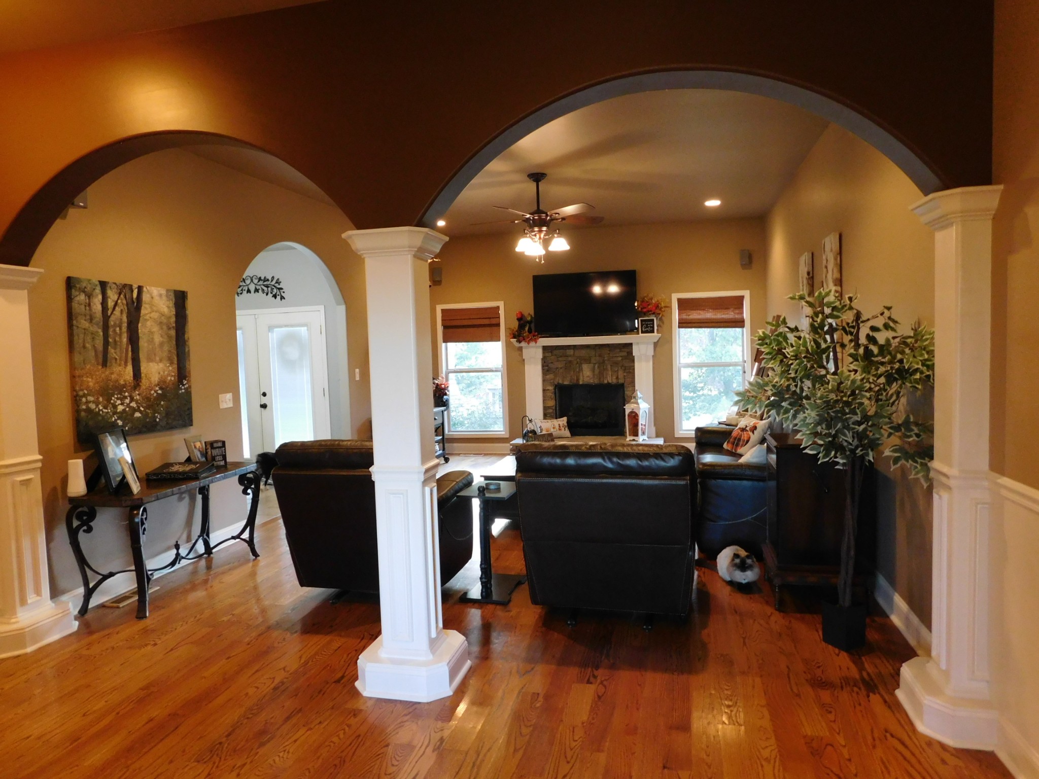 264 Fite Road Watertown, TN 37184 - Photo 20 of 43 a living room with furniture a fireplace and a dining table with wooden floor