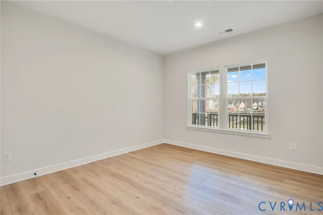 a bedroom with bed and a large window