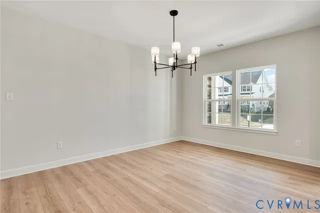 a view of a room with a window and wooden floor
