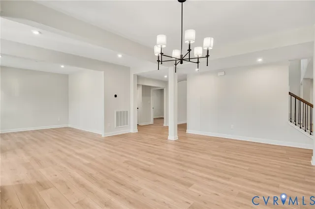 a view of a livingroom with a kitchen and chandelier