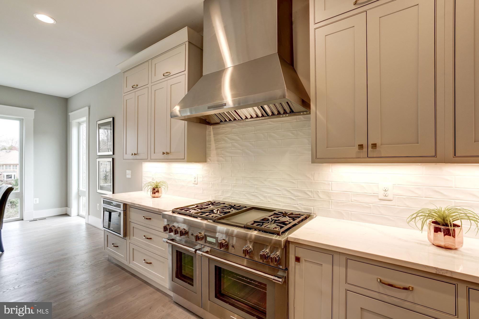 1826 Kirby Road McLean, VA 22101 - Photo 13 of 56 a kitchen with stainless steel appliances a stove a sink and a microwave