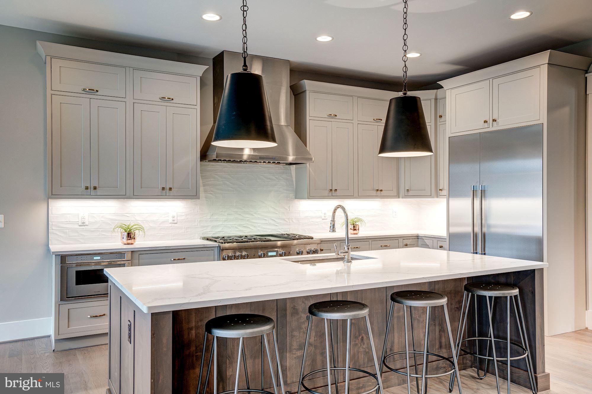 1826 Kirby Road McLean, VA 22101 - Photo 14 of 56 a kitchen with stainless steel appliances granite countertop a sink a stove and a refrigerator