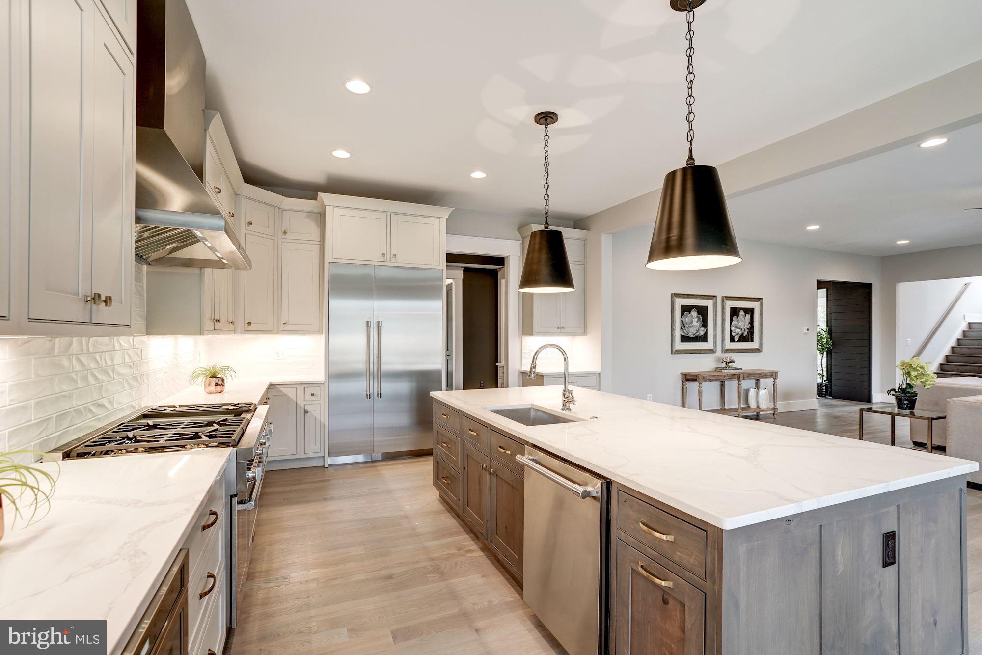 1826 Kirby Road McLean, VA 22101 - Photo 15 of 56 a kitchen with stainless steel appliances a sink a stove a refrigerator and chairs