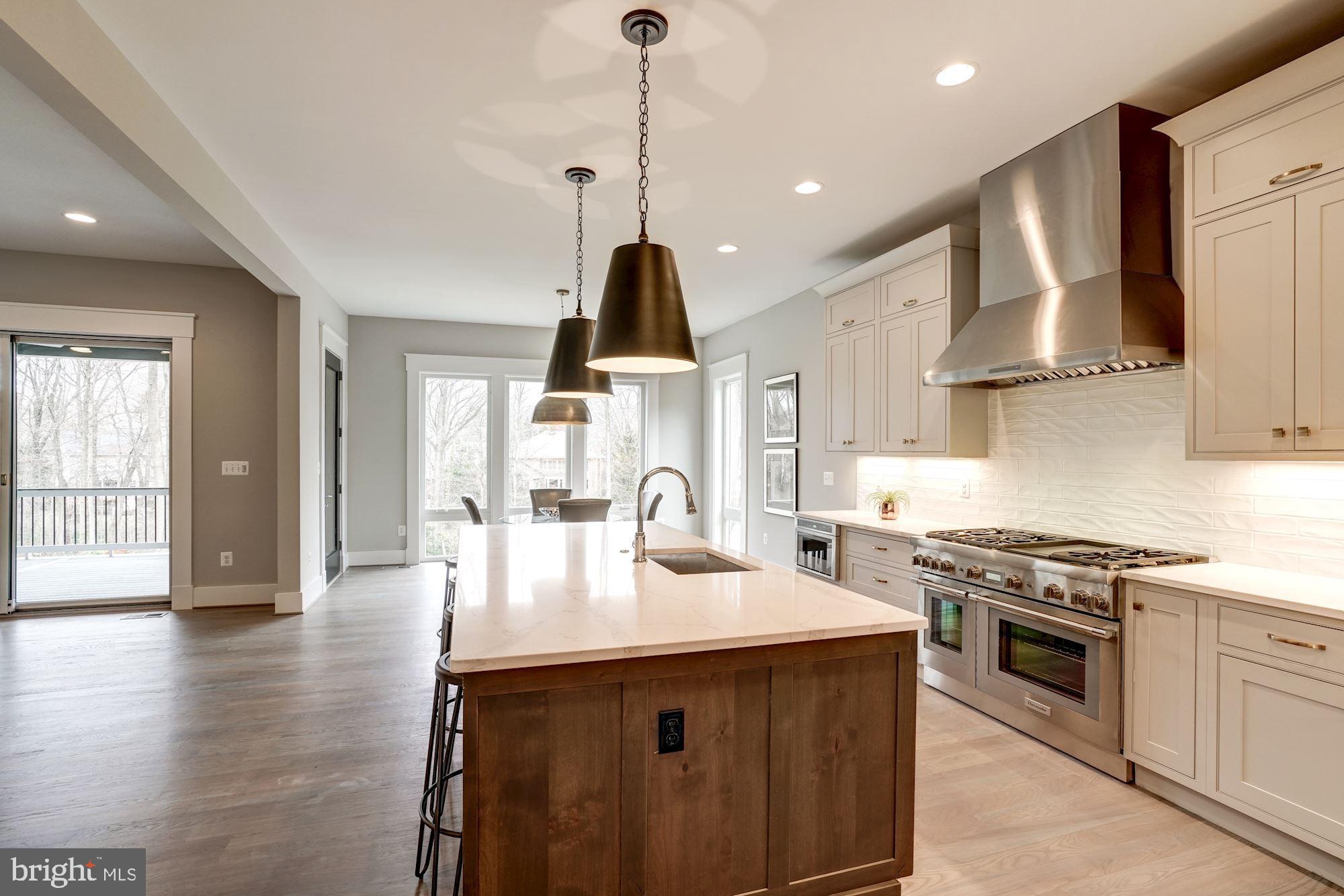 1826 Kirby Road McLean, VA 22101 - Photo 16 of 56 a kitchen with stainless steel appliances granite countertop a sink a stove and a wooden floors