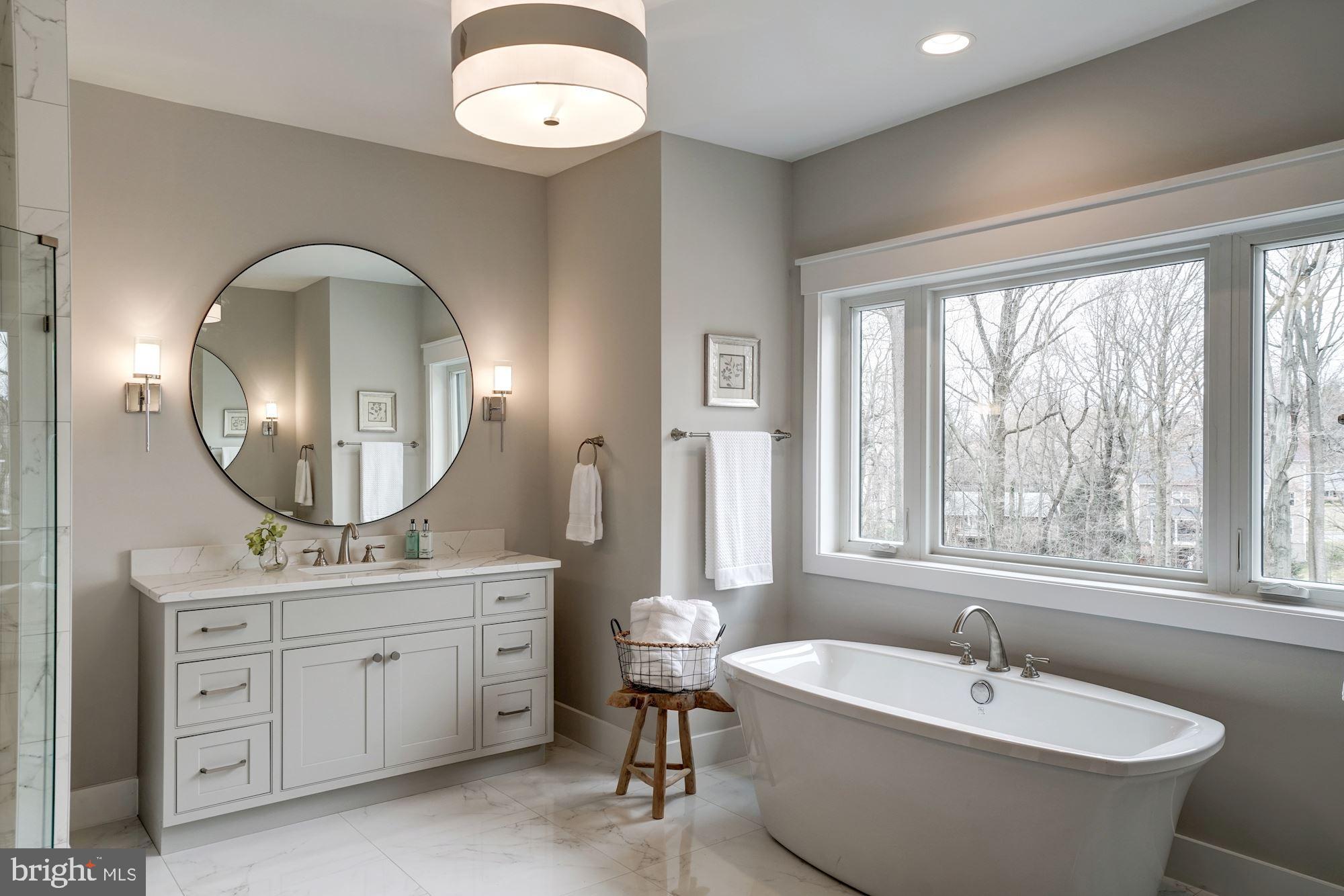 1826 Kirby Road McLean, VA 22101 - Photo 28 of 56 a spacious bathroom with a double vanity sink a mirror and a bathtub
