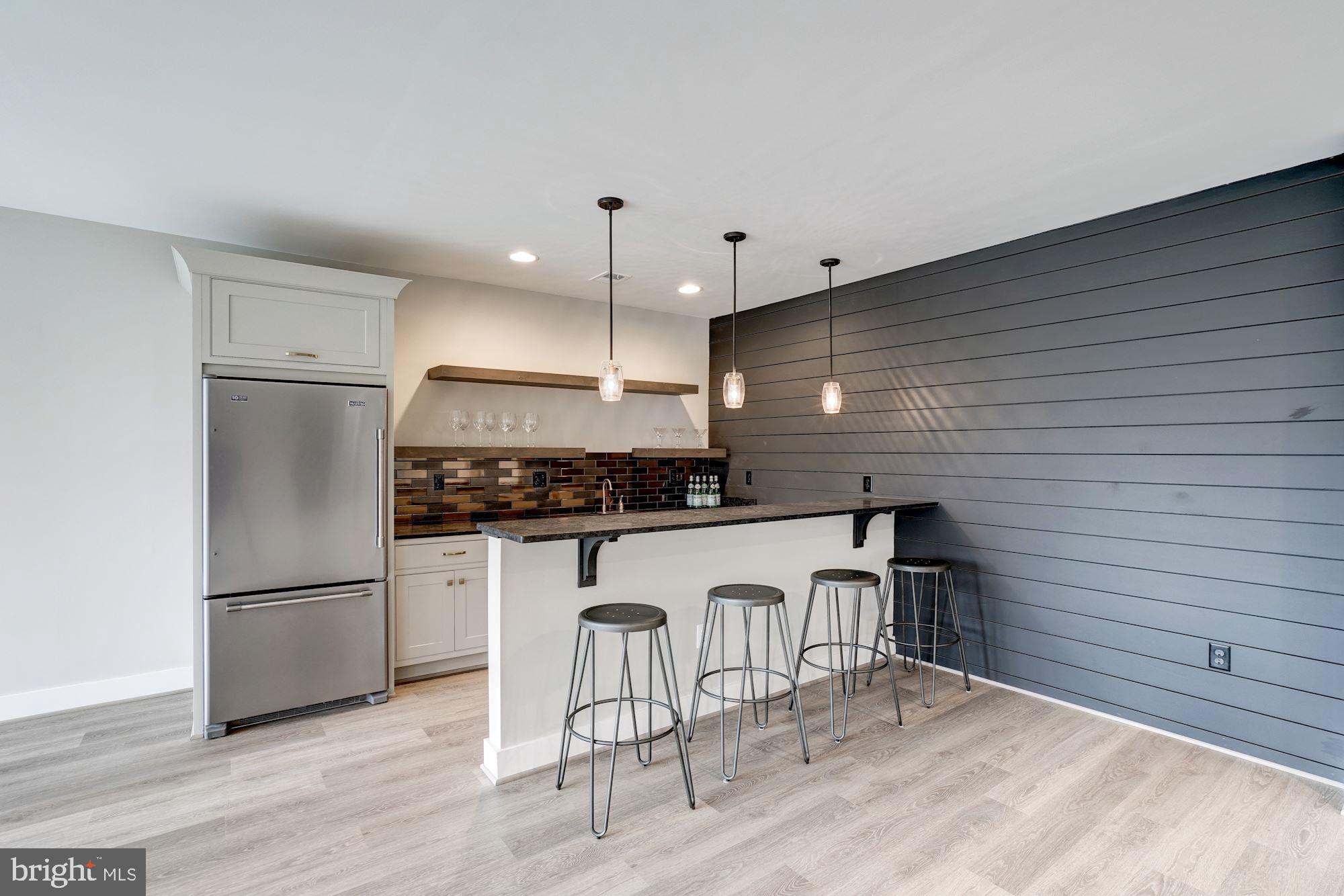 1826 Kirby Road McLean, VA 22101 - Photo 42 of 56 a kitchen with white cabinets stainless steel appliances and kitchen island