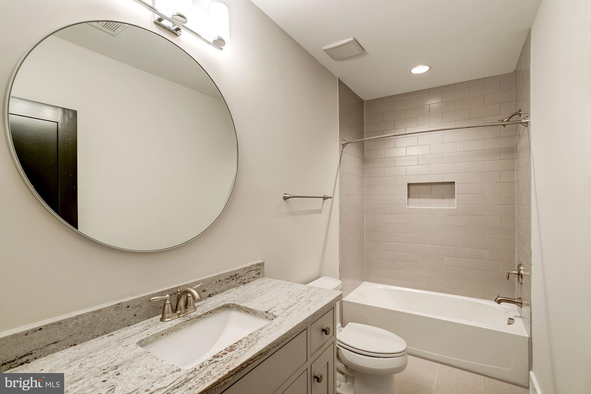 1826 Kirby Road McLean, VA 22101 - Photo 51 of 56 a bathroom with a granite countertop sink toilet and shower
