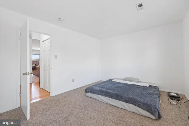 a living room with a dresser and a mirror