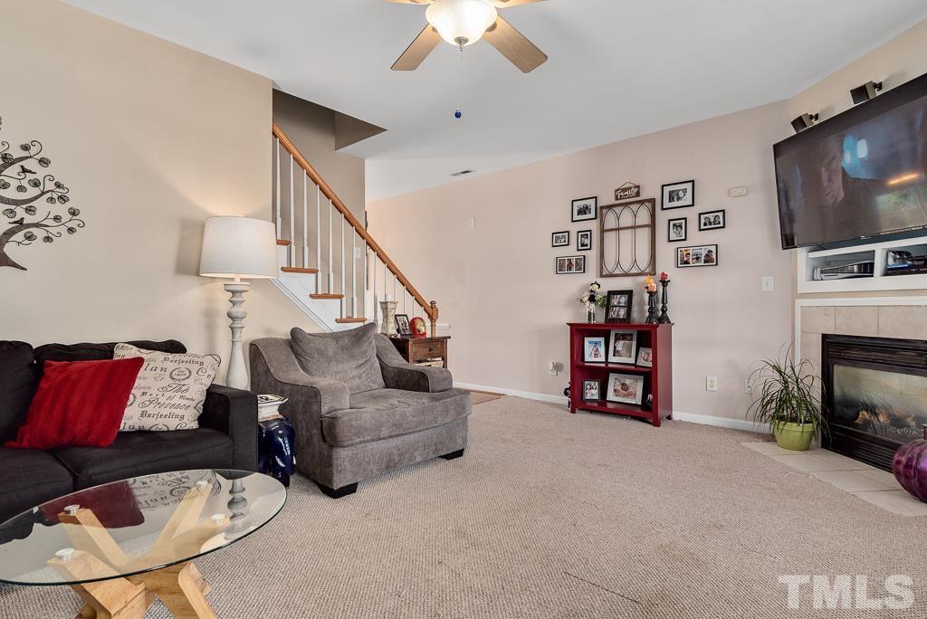 2041 Rivergate Road, Unit 104 Raleigh, NC 27614 - Photo 5 of 21 a living room with furniture and a flat screen tv