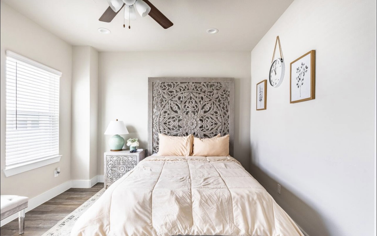 1740 Cove Crescent Houston, TX 77055 - Photo 12 of 44 a bedroom with a bed and a window