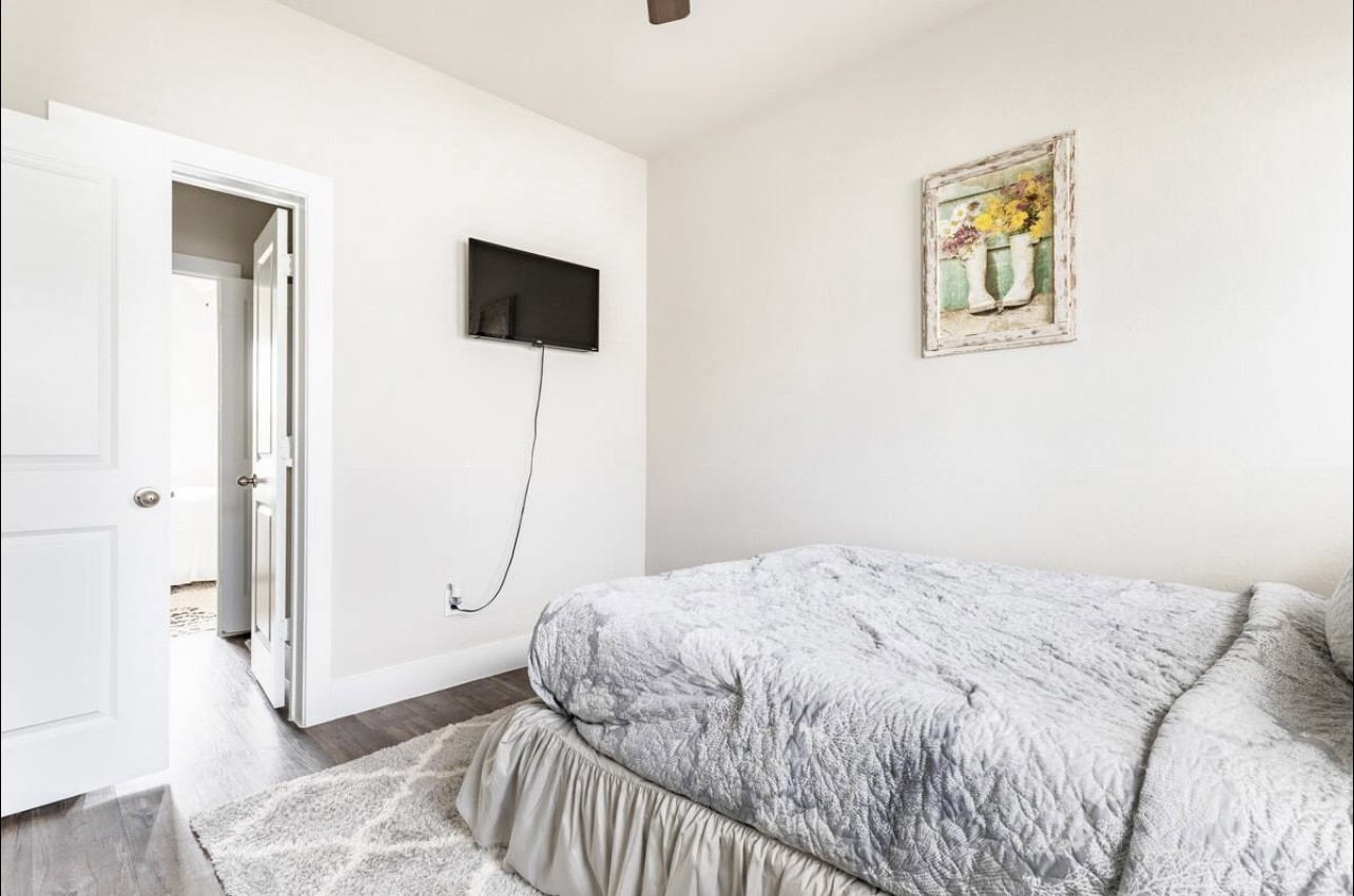 1740 Cove Crescent Houston, TX 77055 - Photo 14 of 44 a bedroom with a bed and a painting on the wall