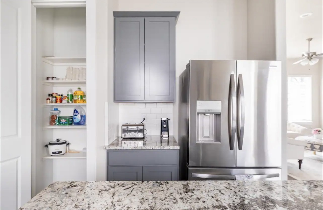 1740 Cove Crescent Houston, TX 77055 - Photo 21 of 44 a kitchen with stainless steel appliances granite countertop a refrigerator and a sink
