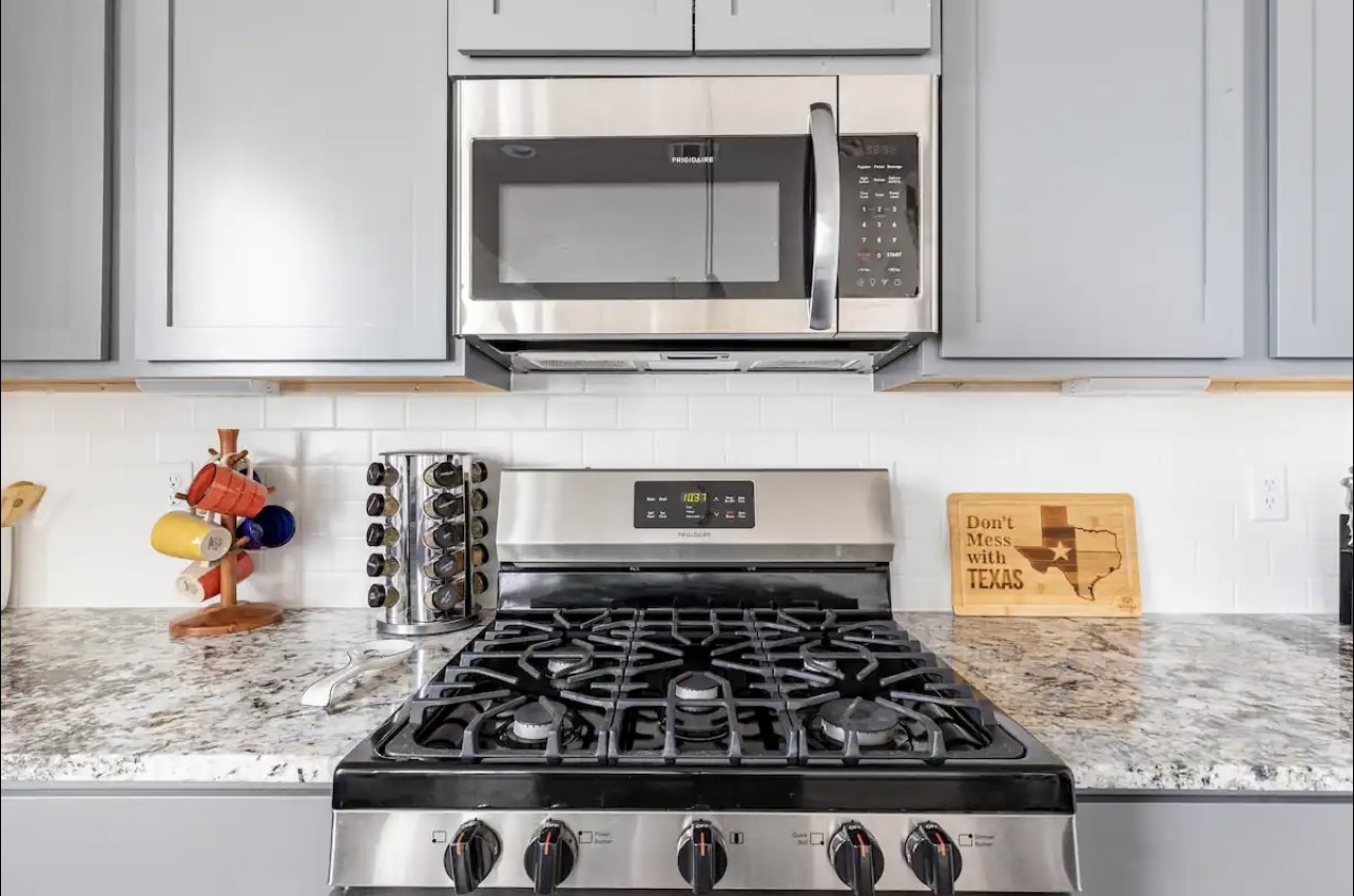 1740 Cove Crescent Houston, TX 77055 - Photo 24 of 44 a kitchen with stove and cabinets