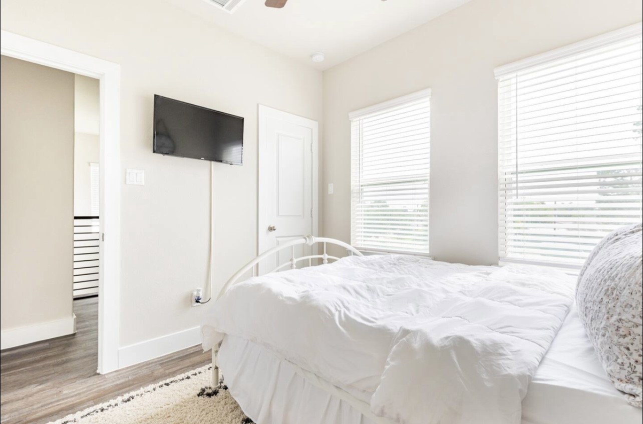 1740 Cove Crescent Houston, TX 77055 - Photo 29 of 44 a large white bed in a white room next to a window
