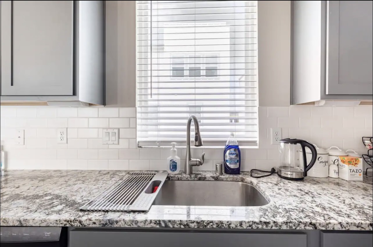1740 Cove Crescent Houston, TX 77055 - Photo 31 of 44 a kitchen with granite countertop a sink and a window