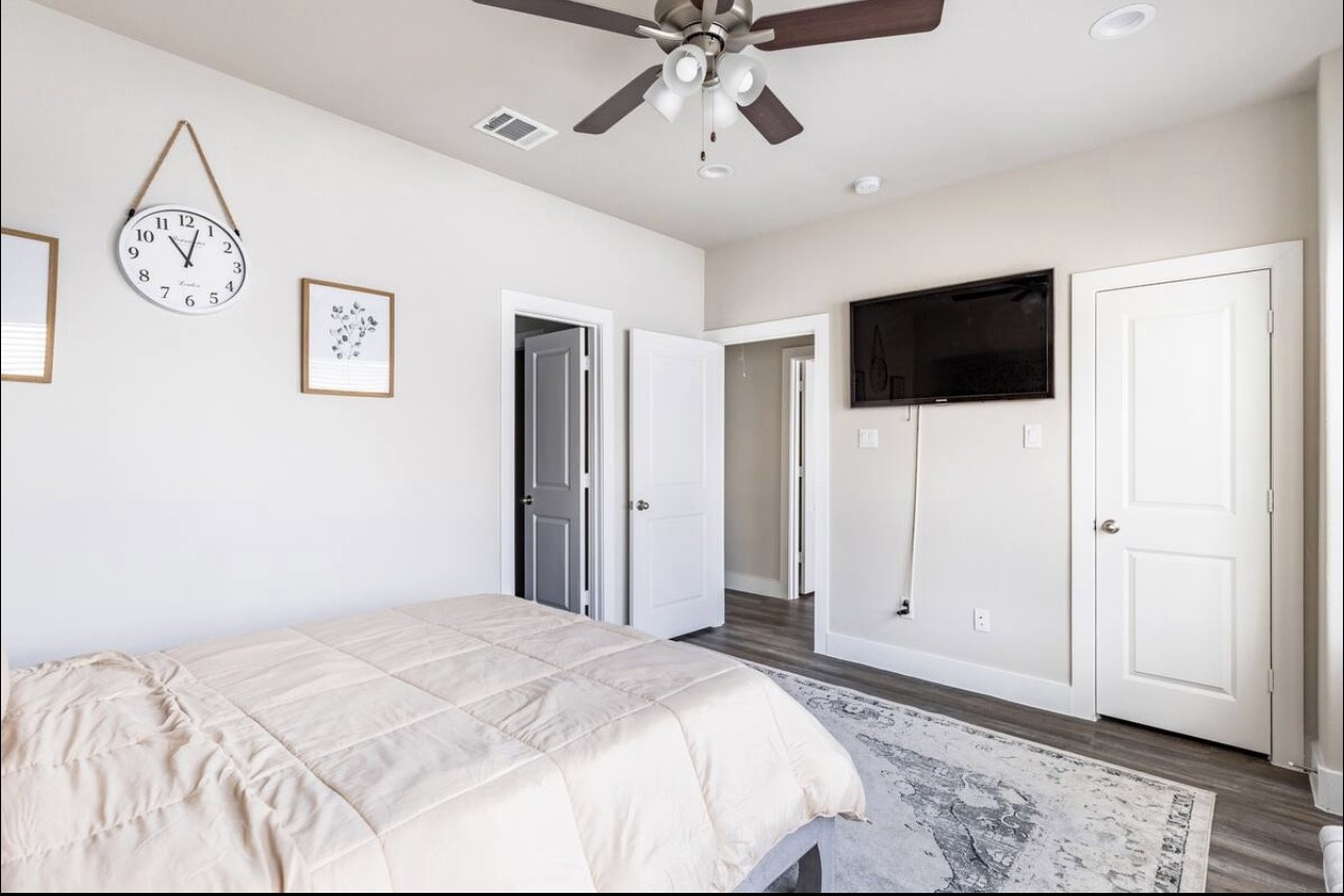 1740 Cove Crescent Houston, TX 77055 - Photo 39 of 44 a bedroom with a bed and a flat screen tv