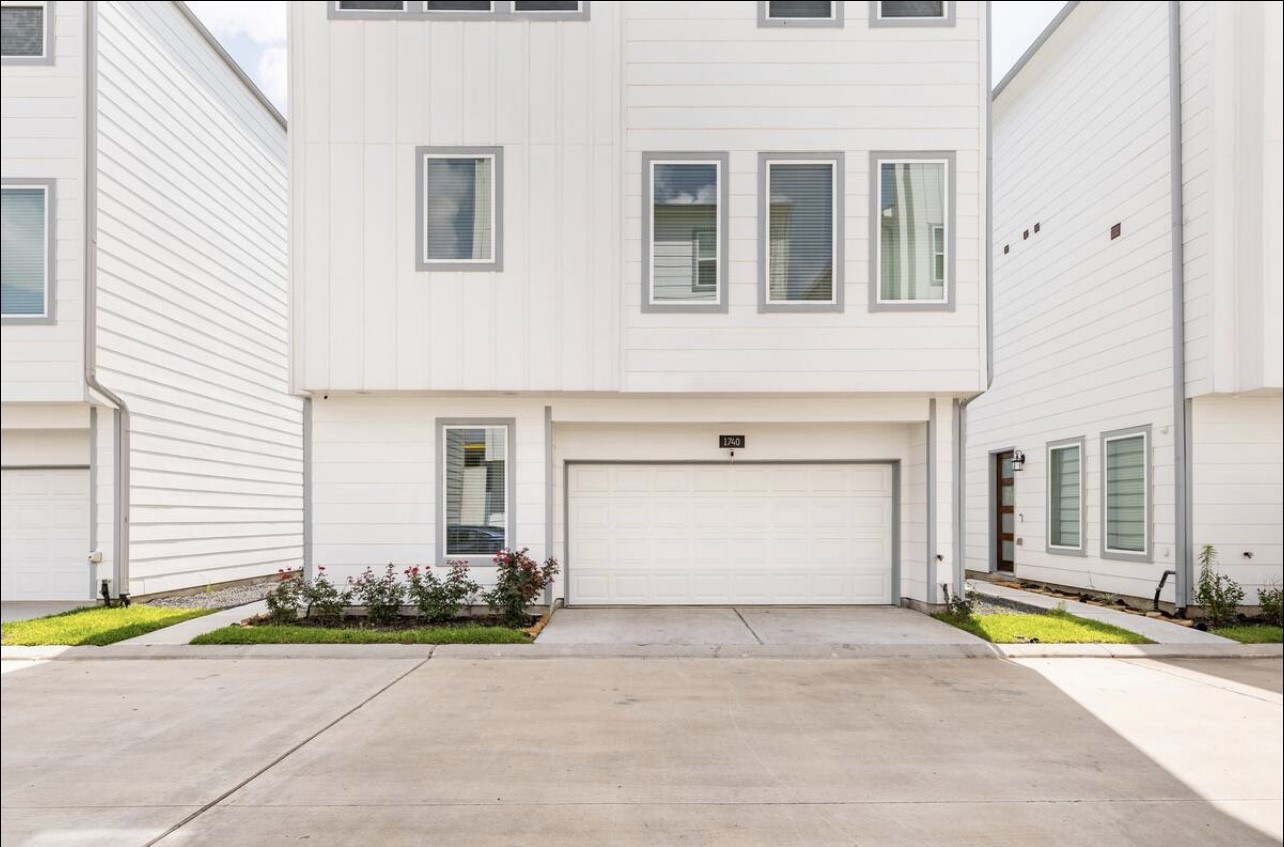 1740 Cove Crescent Houston, TX 77055 - Photo 44 of 44 a front view of a house with a yard and a garage