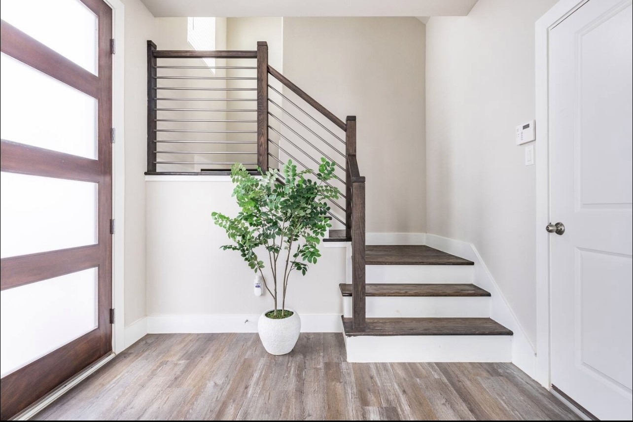 1740 Cove Crescent Houston, TX 77055 - Photo 8 of 44 a view of a porch with wooden floor and a potted plant
