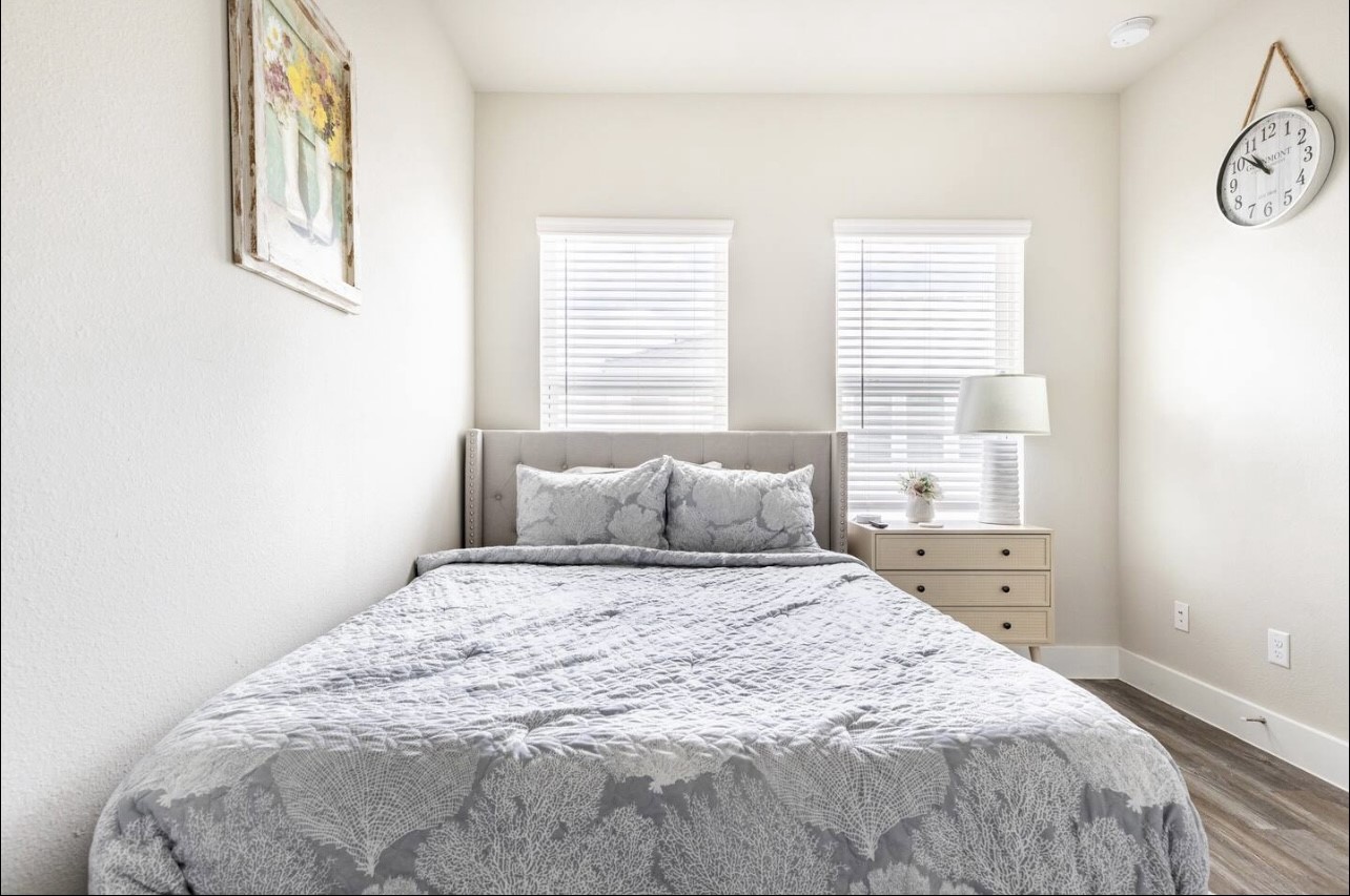 1740 Cove Crescent Houston, TX 77055 - Photo 9 of 44 a large bed sitting in a bedroom next to a window