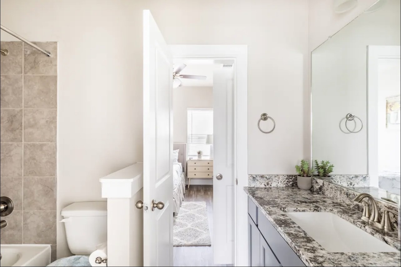 1740 Cove Crescent Houston, TX 77055 - Photo 10 of 44 a bathroom with a granite countertop sink mirror vanity and toilet