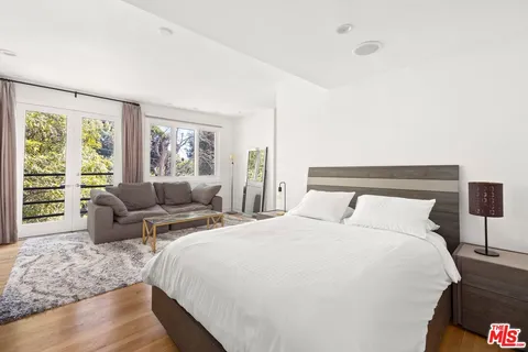 a bedroom with a large bed and a flat screen tv