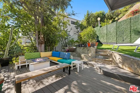 a view of a roof deck with couches and wooden floor
