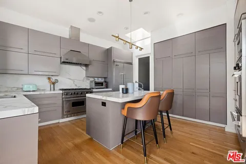 a kitchen with a sink stove and oven