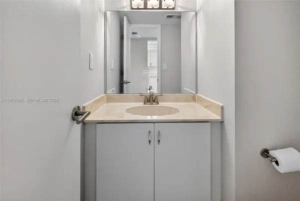a bathroom with a sink and a mirror