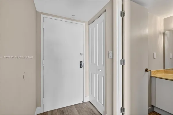 a view of a room with wooden floor