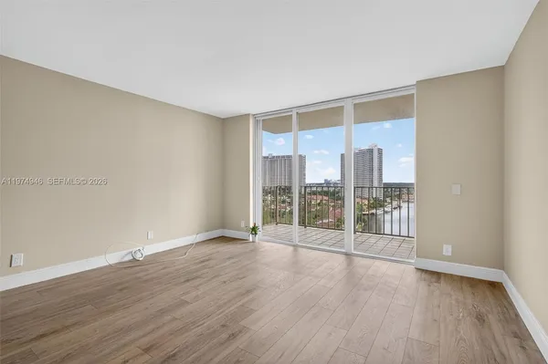 wooden floor in an empty room with a window