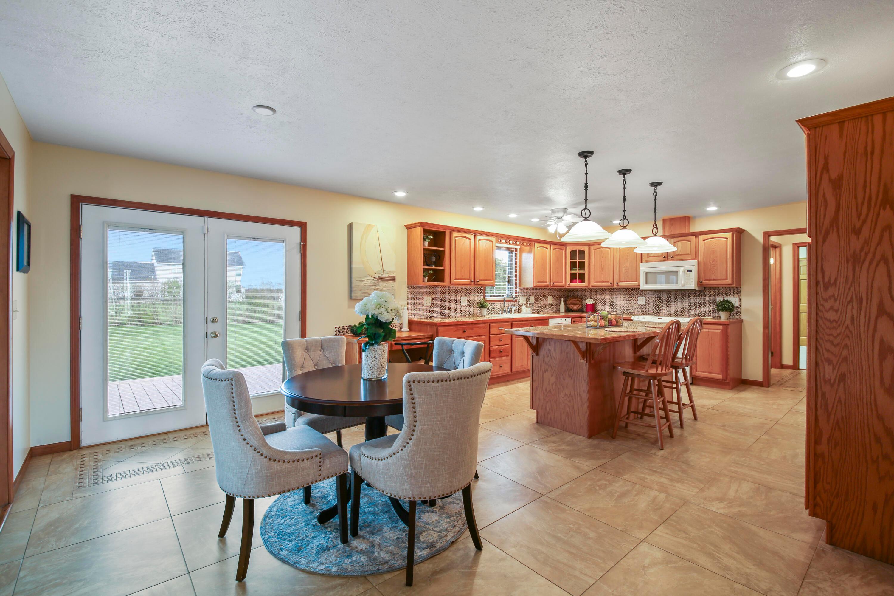 3273 Gooding Road Marion, OH 43302 - Photo 18 of 60 Dinette 9’3 x 15’4 features tile flooring with custom inlay tile work, canned lighting, French doors with built in blinds all leading to the exterior patio and expansive rear yard.