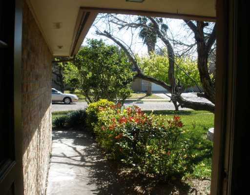 7018 Tamarron Street Corpus Christi, TX 78413 - Photo 2 of 10 a view of a yard with plants and a bench in it