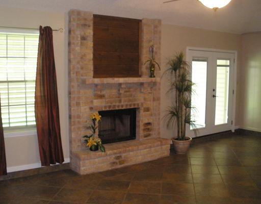 7018 Tamarron Street Corpus Christi, TX 78413 - Photo 3 of 10 a living room with furniture and a fireplace