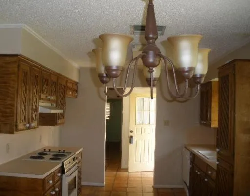 a bathroom with a sink a light fixture and a mirror