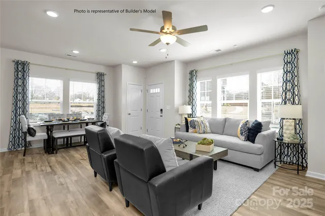 a living room with furniture and large windows